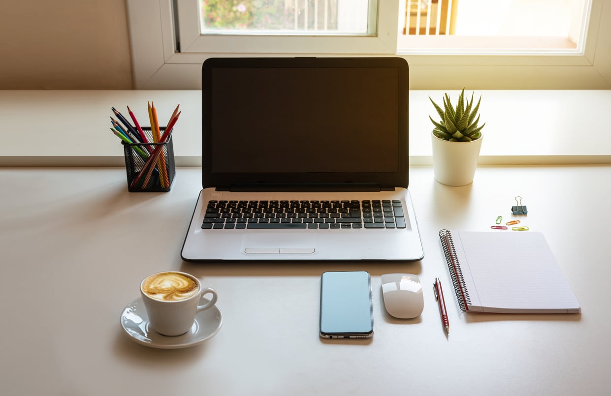 Desk with Laptop, Work Accessories and Coffee